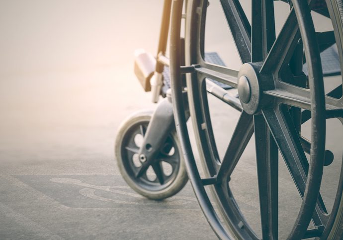 close up view of  wheelchair with Pavement handicap symbol